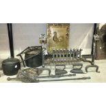 A wrought iron fire grate, dogs and fire back, together with iron cooking pots, pot hanger and