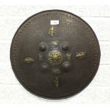 An Asian metal shield applied with brass animals and figures, 44cm diameter.