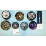 Three Okra Glass Studios paperweights, 'Black Tower' 13/150, 'Nebular' No.15 and one other floral