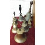 A rosewood-handled hand bell with iron clapper, 30cm high and nine other hand bells, (10).