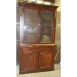 A Victorian mahogany bookcase, the cornice above a pair of glazed doors, a drawer and cupboard