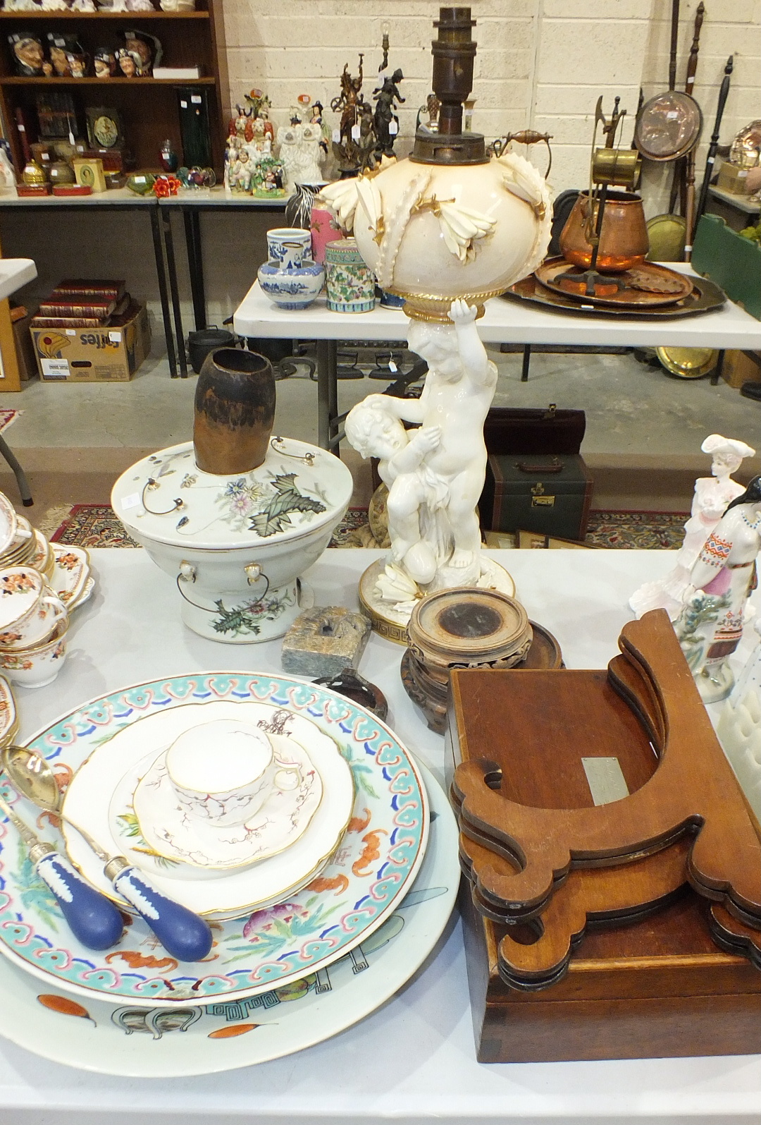 A modern Oriental ceramic charger, 37cm diameter, four carved Oriental wood bowl stands and other