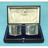 A pair of Walker & Hall cased octagonal-shaped silver napkin rings, Birmingham 1931.