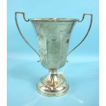 A silver two-handled trophy cup of octagonal form with flared top, on circular base, inscribed