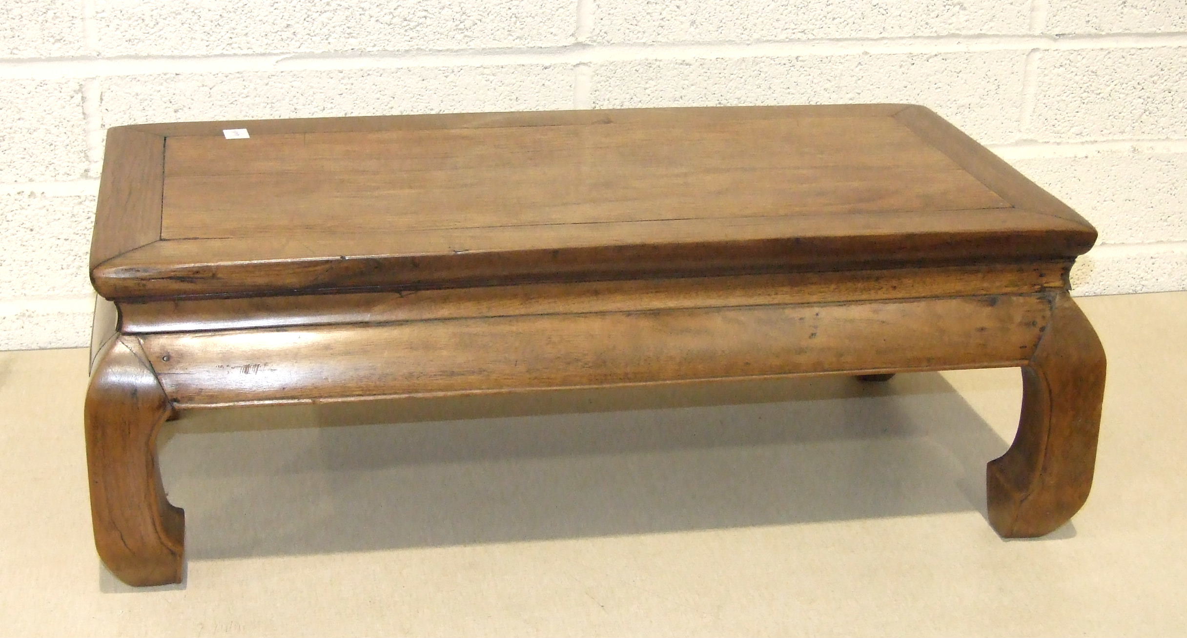 A late-19th/early-20th century Chinese hardwood low table on short shaped legs, 71 x 40cm,