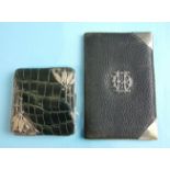 An early-20th century reptile skin folding purse with fitted leather interior and silver leaf and