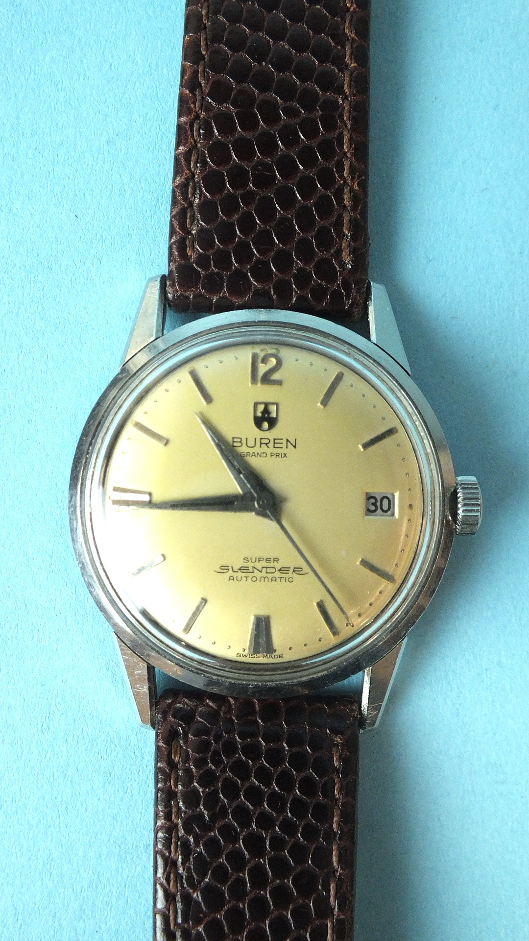 Buren, Grand Prix Super Slender Automatic steel-cased gentleman's wrist watch, the gilt dial with