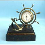 A late-19th century aneroid barometer in the form of a brass ship's wheel mounted together with an