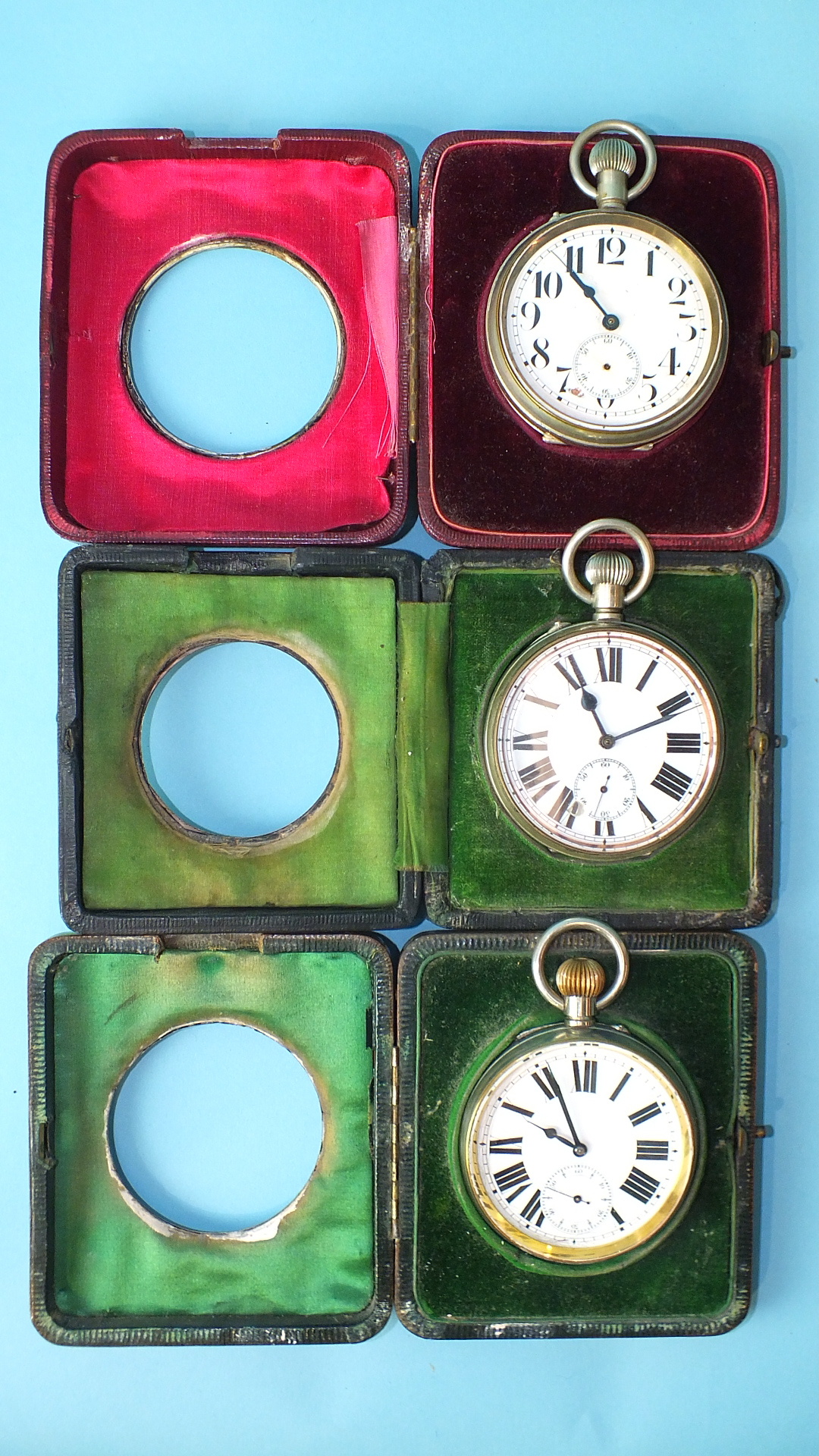 A beaten-silver-mounted leather travelling watch stand with nickel-cased Goliath keyless watch,