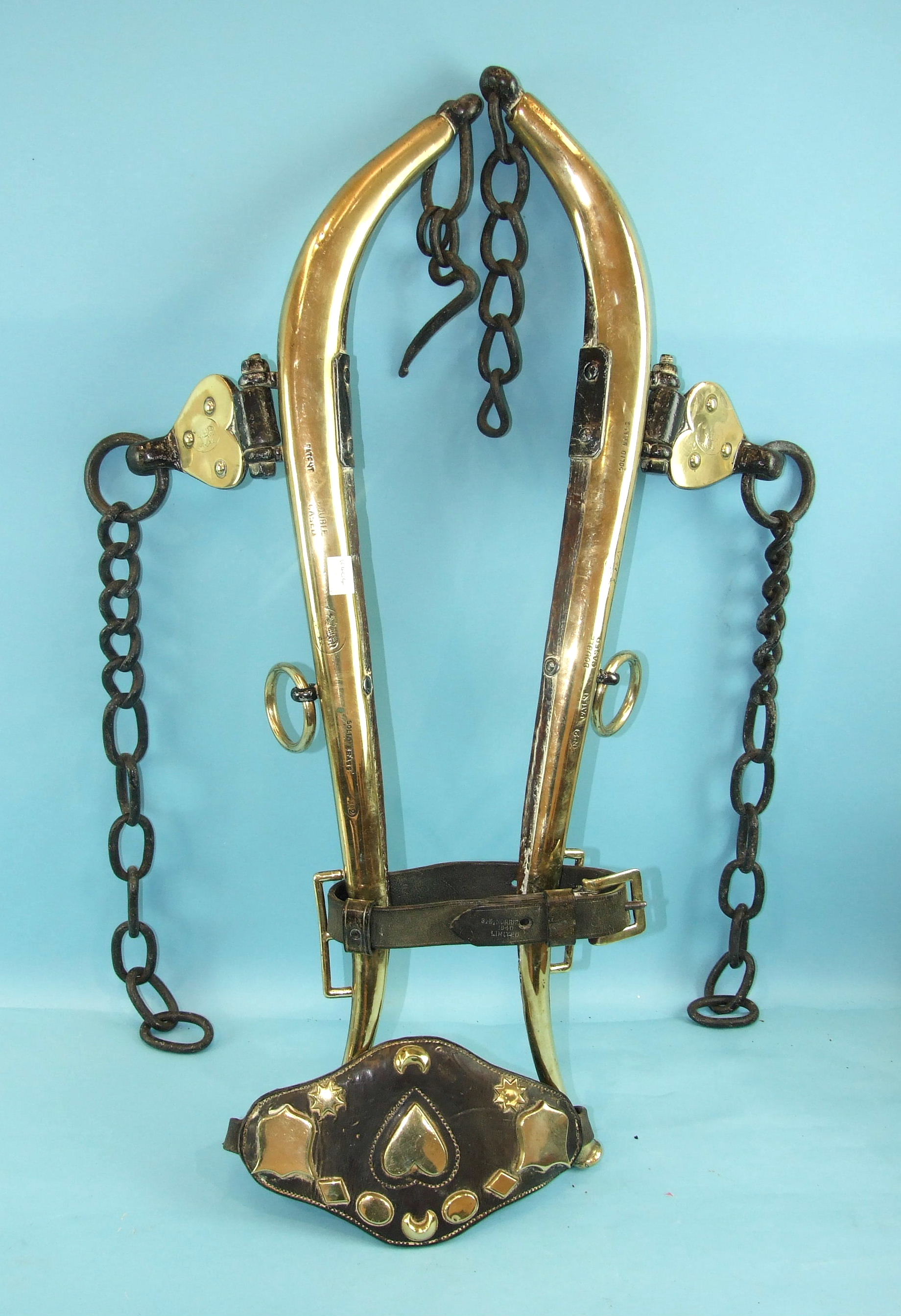 A pair of brass horse hames with leather end brasses attached, leather strap stamped 'S E Norris