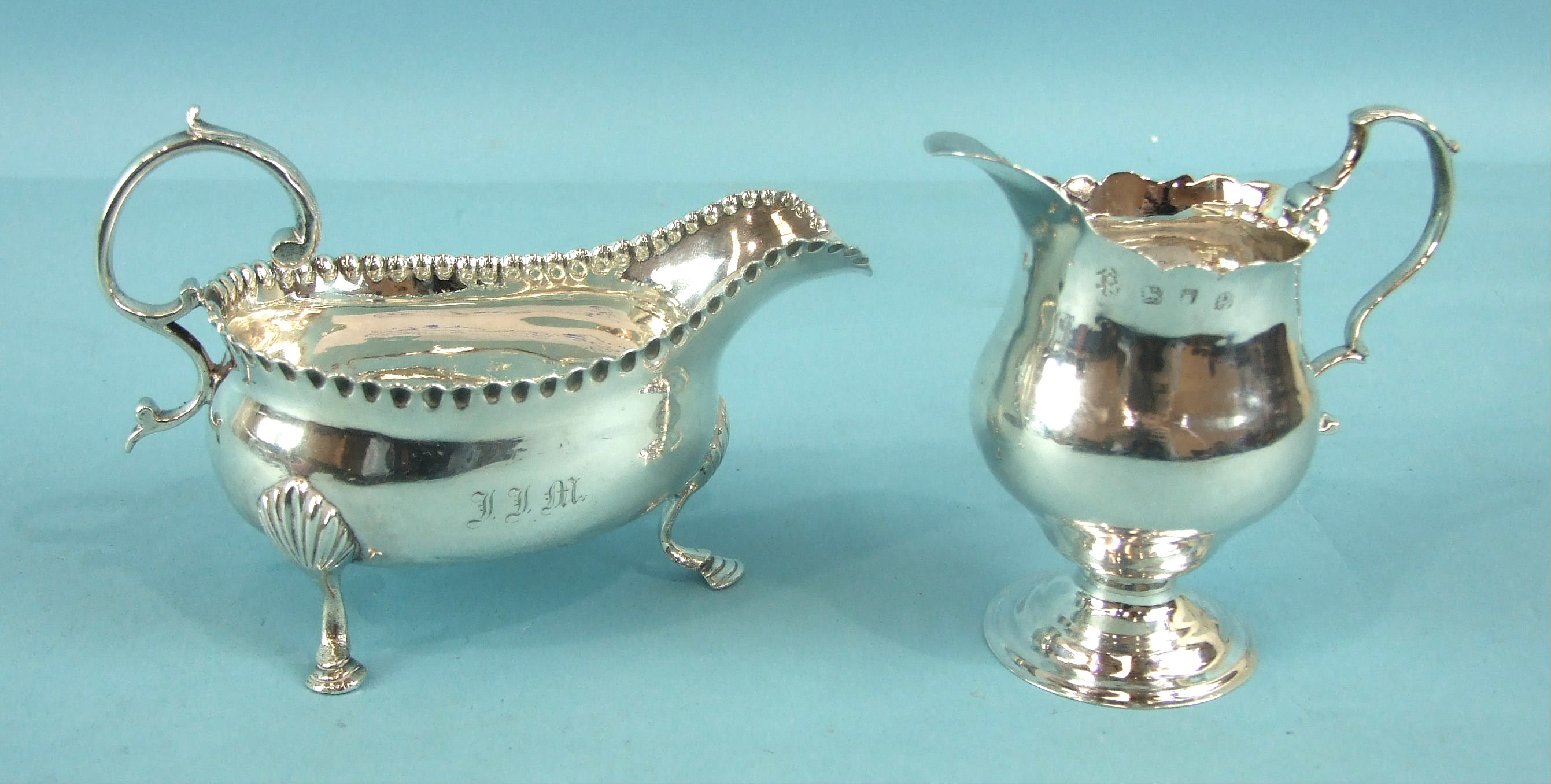 A George III small sauce boat with scroll handle, pressed bead border and three shell and hoof legs,