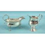 A George III small sauce boat with scroll handle, pressed bead border and three shell and hoof legs,