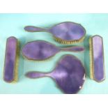 A silver and purple-enamelled dressing table set, comprising: two hair brushes, a clothes brush