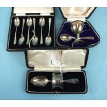 An egg cup and spoon in fitted box, Birmingham 1909, a napkin ring and spoon in case, London 1927