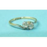 A two-stone diamond cross-over ring claw-set two brilliant-cut diamonds of approximately 0.2cts