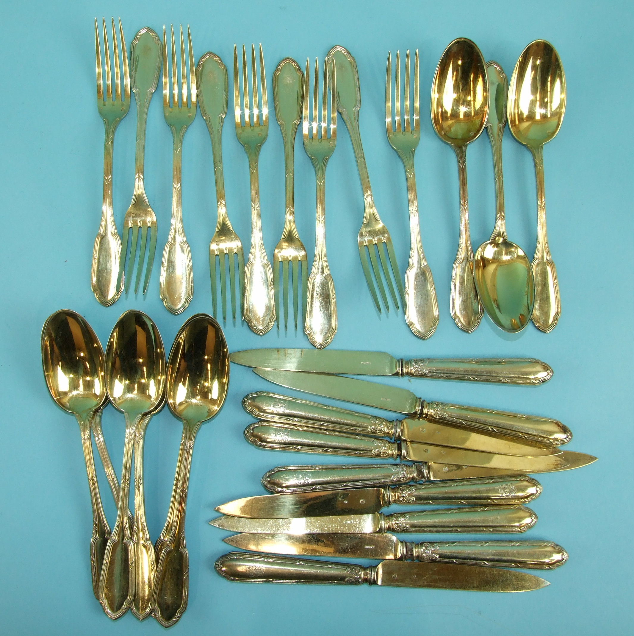 A set of nine each French silver gilt dessert spoons, table forks and knives with loaded handles, - Image 2 of 3