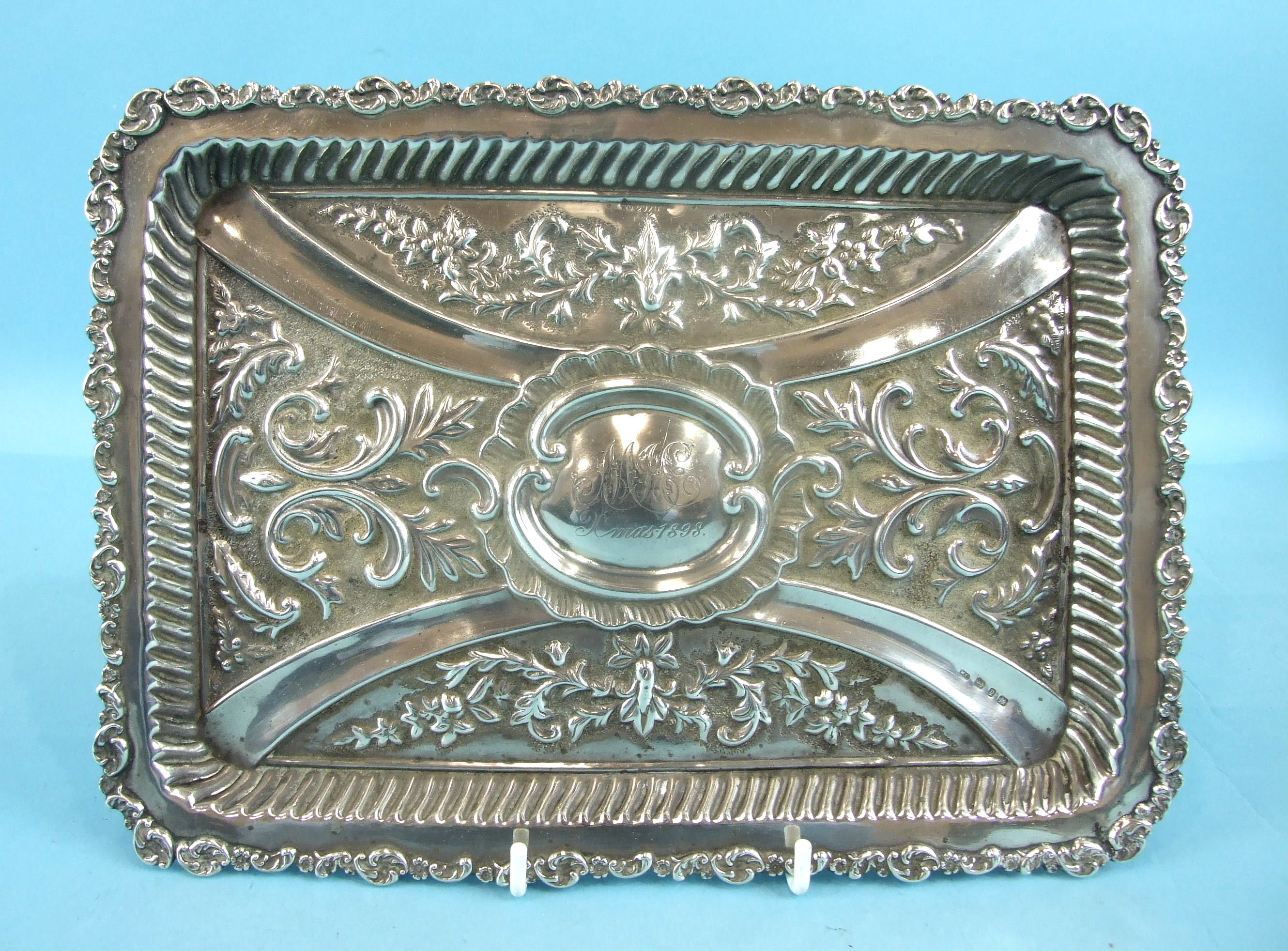 A late-Victorian rectangular foliate embossed tray, with engraved central cartouche, 'Xmas 1898',