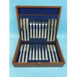 A set of twelve each plated dessert knives and forks, with loaded white metal foliate handles in