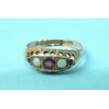 An Edwardian 9ct rose gold gipsy ring set three rubies and two opals, size M.