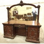 A large Victorian mahogany sideboard, the mirrored back above an arrangement of drawers and pedestal