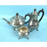 A plain circular teapot, coffee pot and cream jug by Goldsmiths & Silversmiths Co. Ltd, on pad feet,