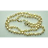 A string of slightly-graduated cultured pearls with concealed pearl clasp, 57cm.