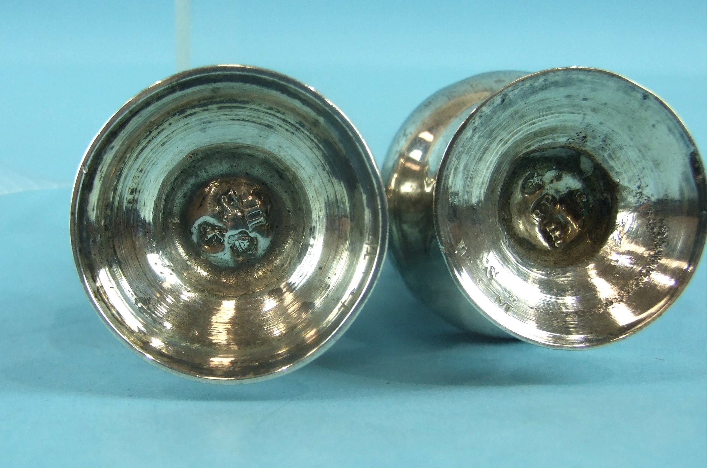 Two Georgian pepper castors of baluster form, 1747 and 1767, one with damaged lid, 12cm high, (2). - Image 2 of 2