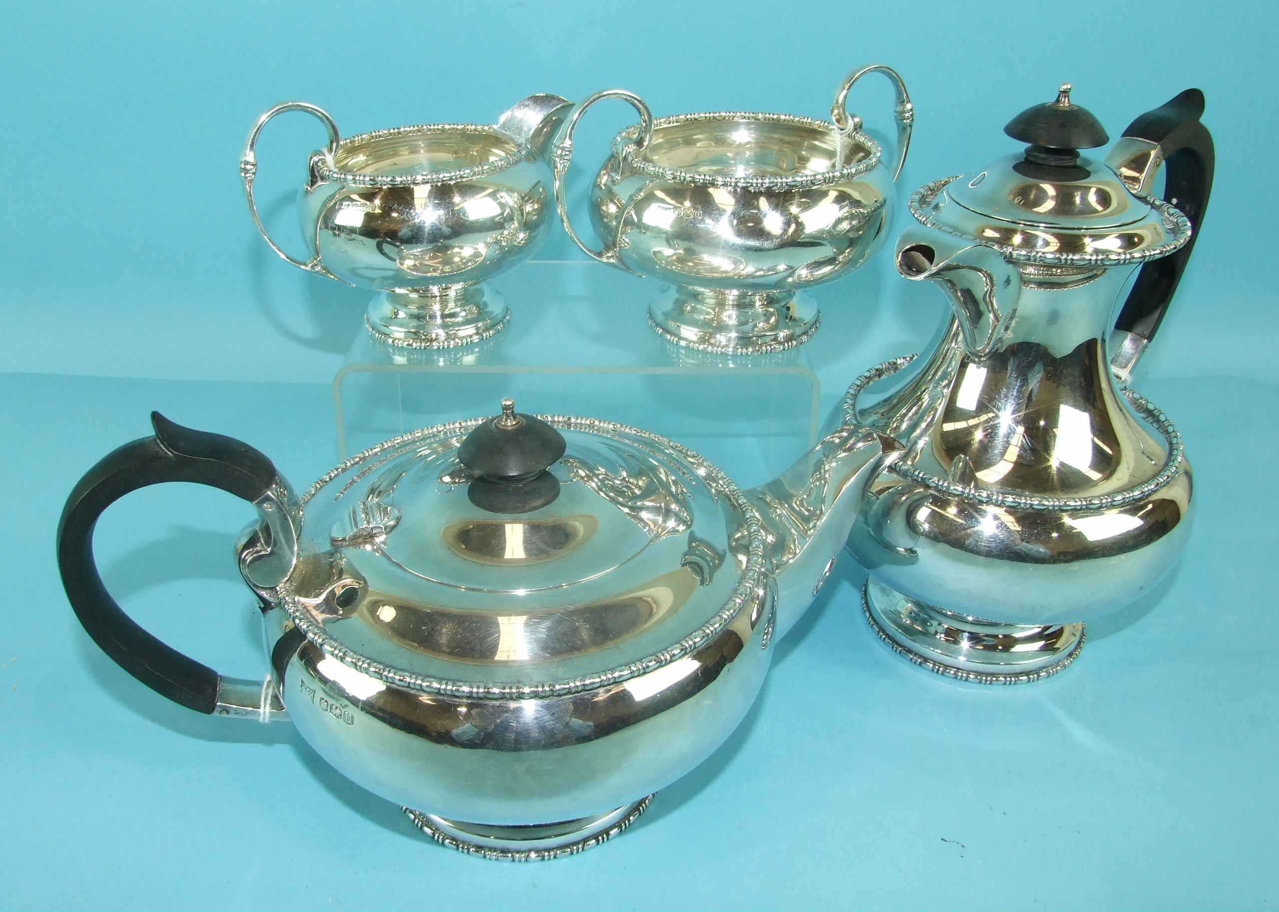A four-piece Walker & Hall silver tea service with beaded rim decoration, comprising a teapot of