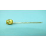 A stick pin claw-set a yellow chrysoberyl, in yellow gold mount, (tests as 18ct approximately),