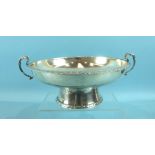 An Elizabeth J Fairbairns plain shallow bowl on stand, with foliate borders and leaf-capped handles,