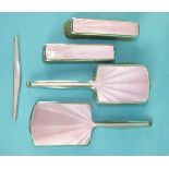 A mid-20th century pink-enamelled and silver dressing table set comprising: hair brush, two