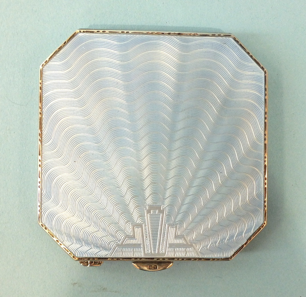 An octagonal silver powder compact by William Neale and Son Ltd, with pale blue guilloche-