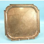 A late-Victorian small salver of square form with shaped corners, on four feet, engraved with stag's