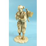 A Japanese sectional ivory figure of a man carrying a goose on his back, signed, 18cm high, (