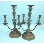 A pair of pewter three-light table candelabra on circular bases, 36cm high, (2).