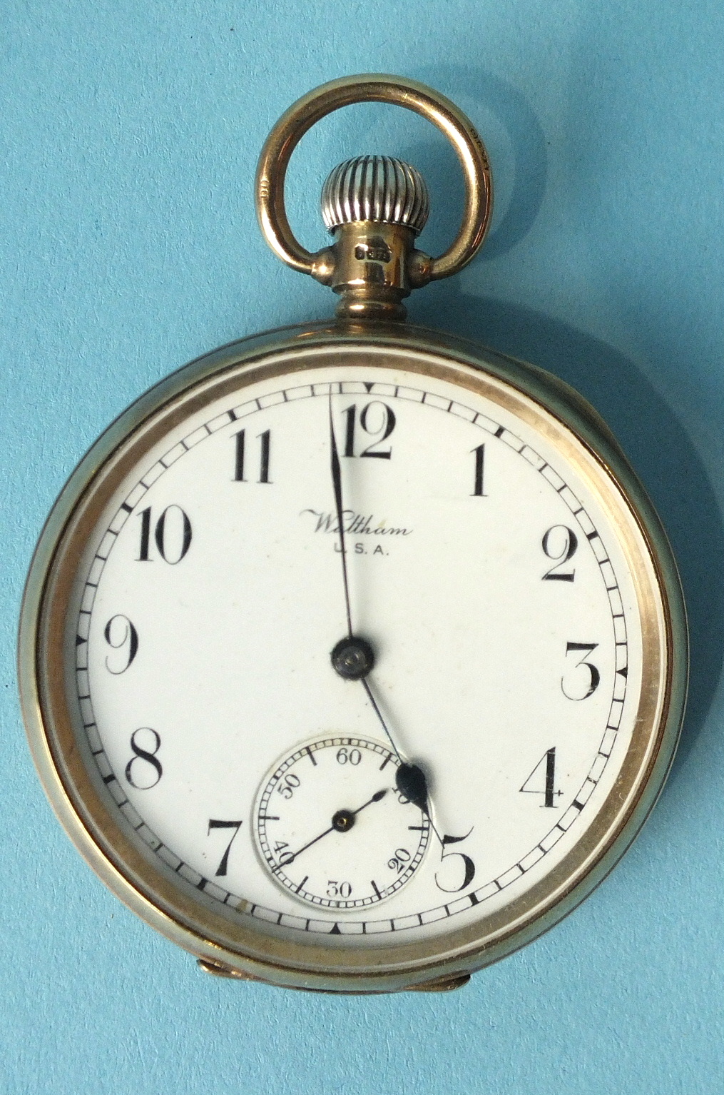 Waltham, a 9ct-rose-gold-cased open-face keyless pocket watch, the white enamel dial with Arabic