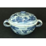 An 18th century Dutch Delft broth bowl and cover decorated with Chinese figures, 'I VS' to cover and