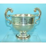 A small silver trophy cup fitted with two scroll handles and inscribed "Cotley Harriers Hunter