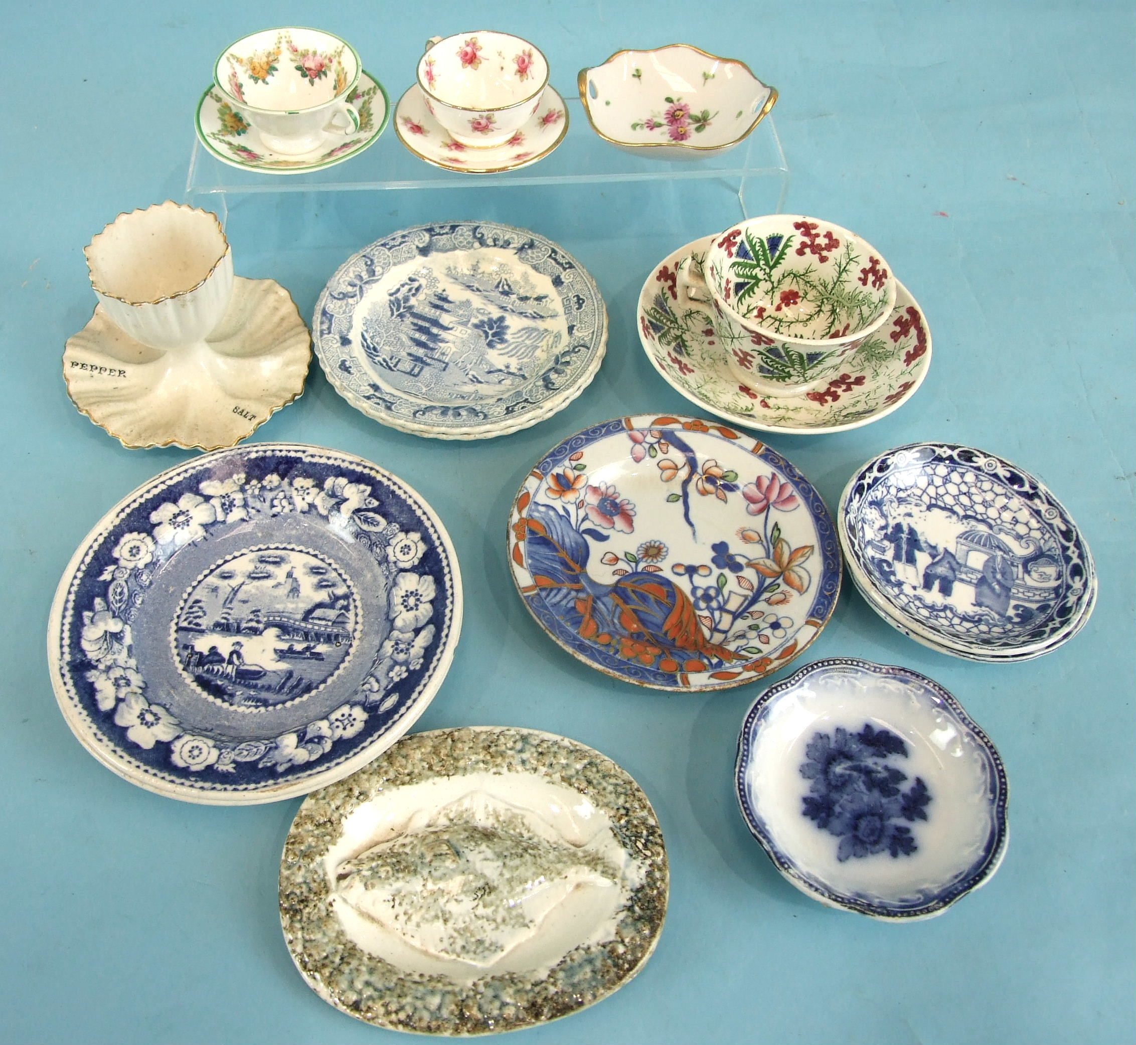 A group of child's plates with willow pattern and other printed decoration, also an egg cup, etc.