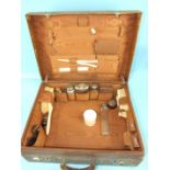 A Victorian leather dressing case partially-fitted with silver-mounted glass bottles, London 1883.