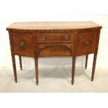 A George III mahogany bow-fronted sideboard having two central drawers, a cupboard door and deep