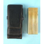 A Dunhill gold-plated lighter, 64mm, with ribbed decoration and leather pouch.