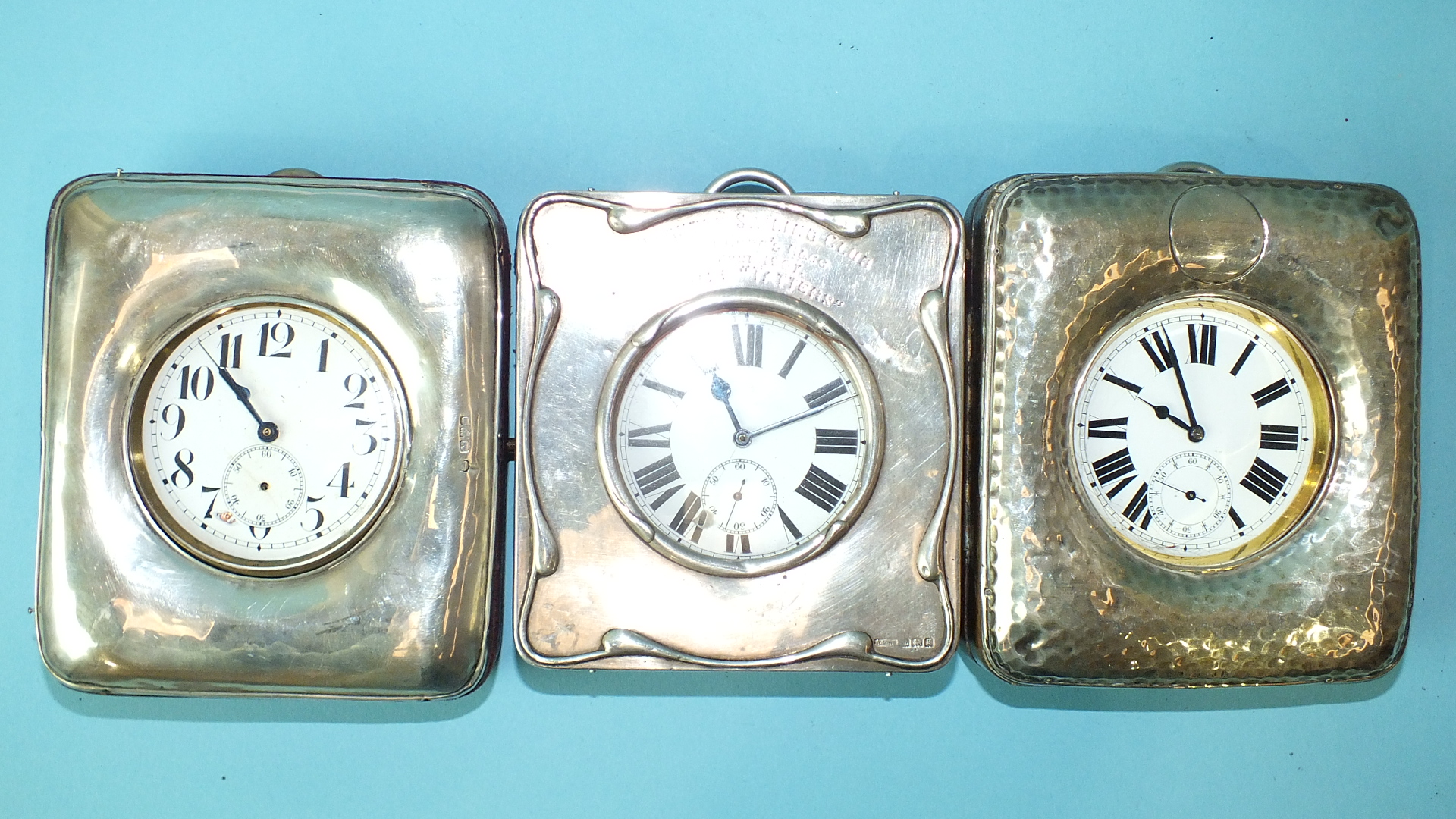 A beaten-silver-mounted leather travelling watch stand with nickel-cased Goliath keyless watch, - Image 2 of 2