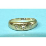 An 18ct gold gipsy ring set three diamonds, size M½, 3.9g.