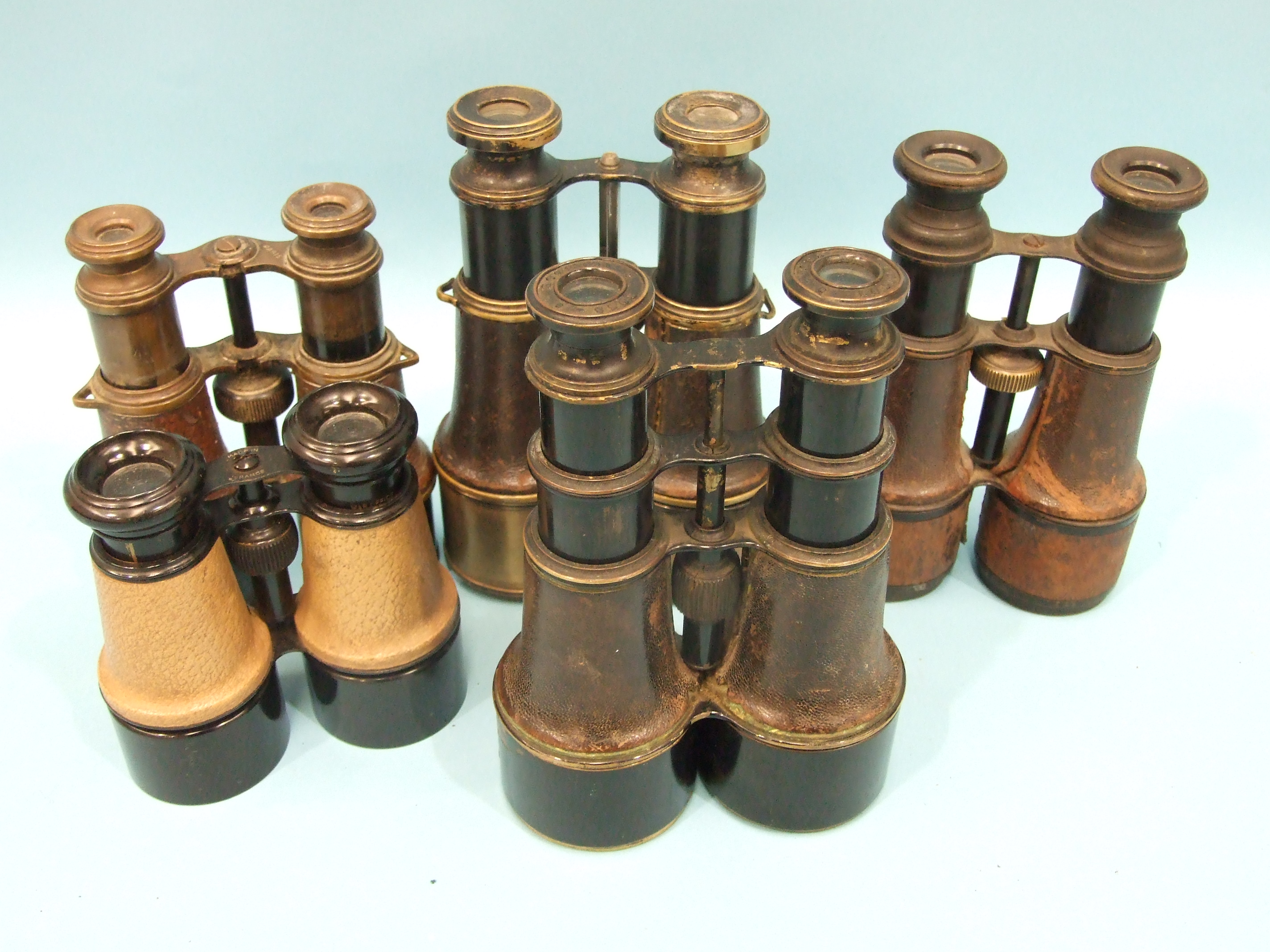 A pair of japanned brass binoculars with leather-covered barrels, eyepieces marked 'Ross, London'