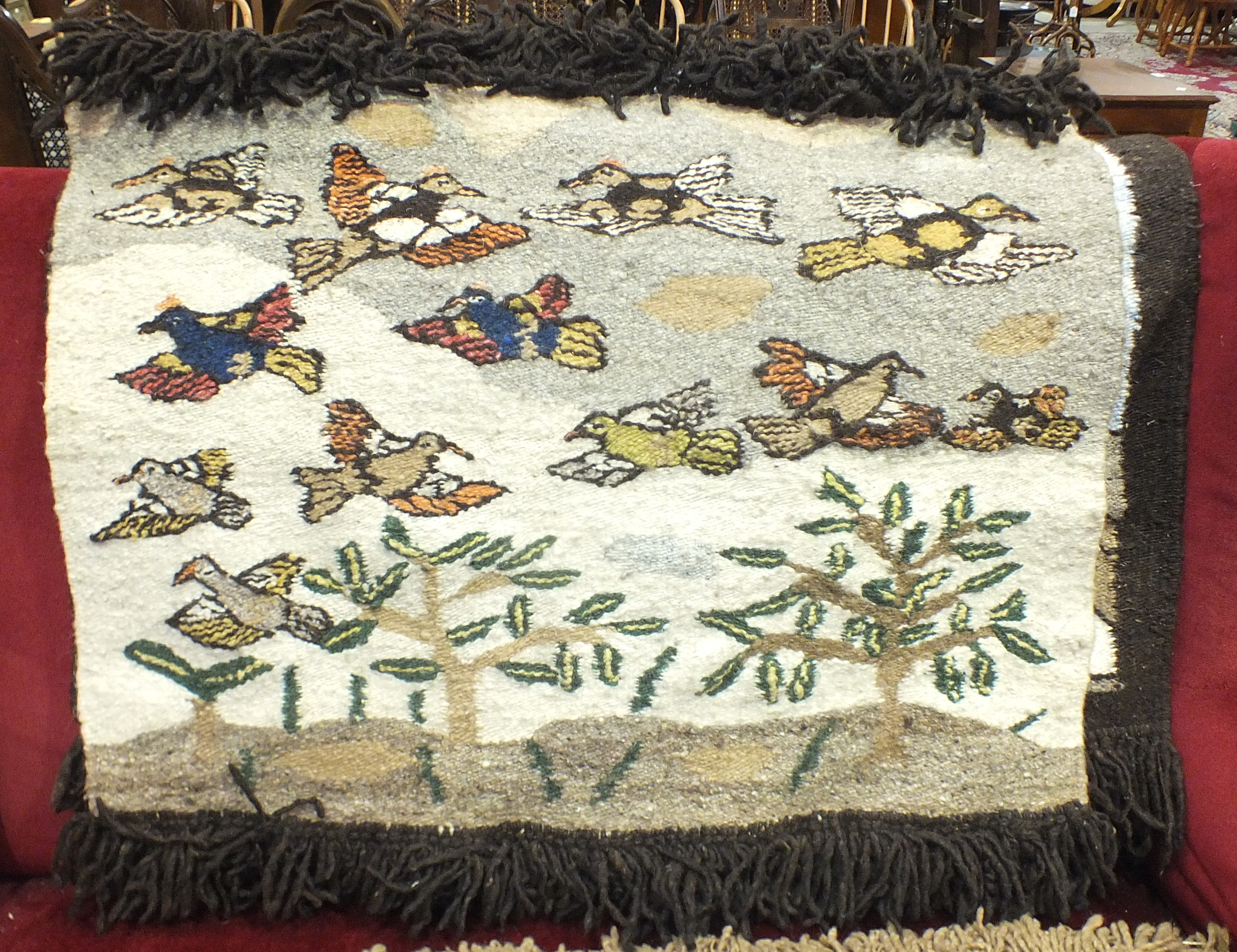 A wool tapestry 'Many Birds', 70 x 91cm, titled on label 'Handmade in Lebowa' and two other wool
