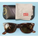 Ray-Ban, a pair of Wayfarer sunglasses with tortoiseshell-style frames and case.