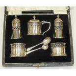 A five-piece silver condiment set with blue glass liners, in fitted case, Birmingham 1926, 27,