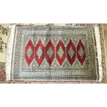 A collection of three modern Eastern-style rugs, largest 136 x 79cm and a slip mat, (4).