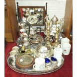 A four-piece plated tea service by M & Co, a two-handled oval tray, a pair of brass candlesticks,